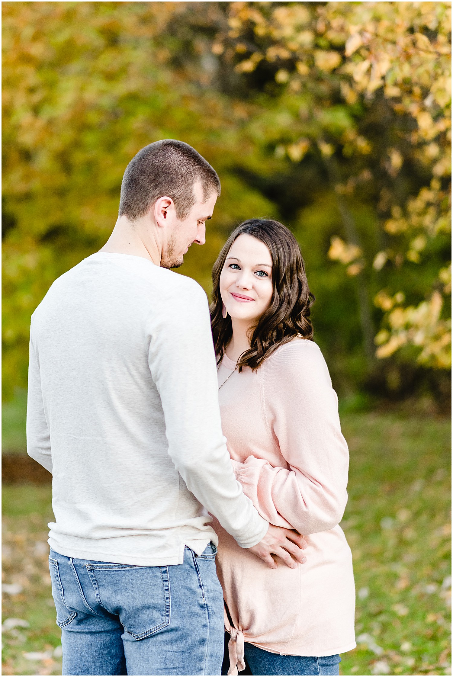 couple posing in park maternity session