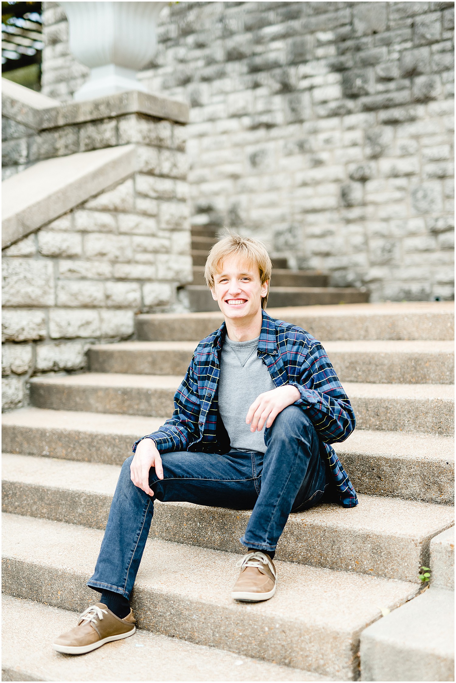 senior boy sitting on stairs smiling jefferson city senior session