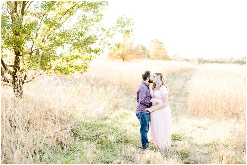 fall grasses field couple kissing in field maternity session