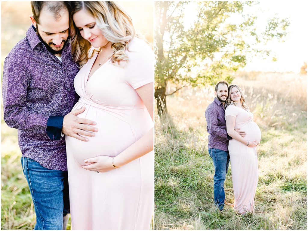 couple holding baby belly in front of tree fall sunlight fall fields st Joseph mo maternity session