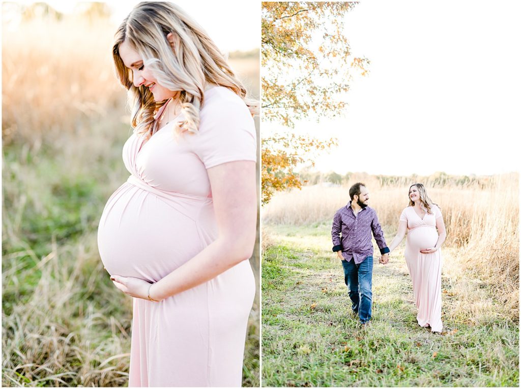 couple walking through field holding baby belly maternity session
