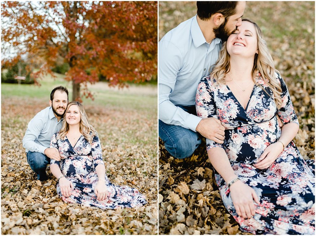 couple sitting in leaves posing and kissing st Joseph mo maternity session