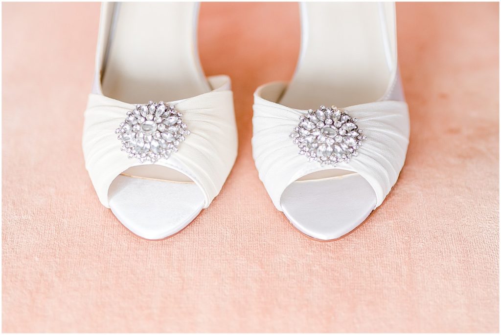 bridal shoes white with chrystal detail on pink chair