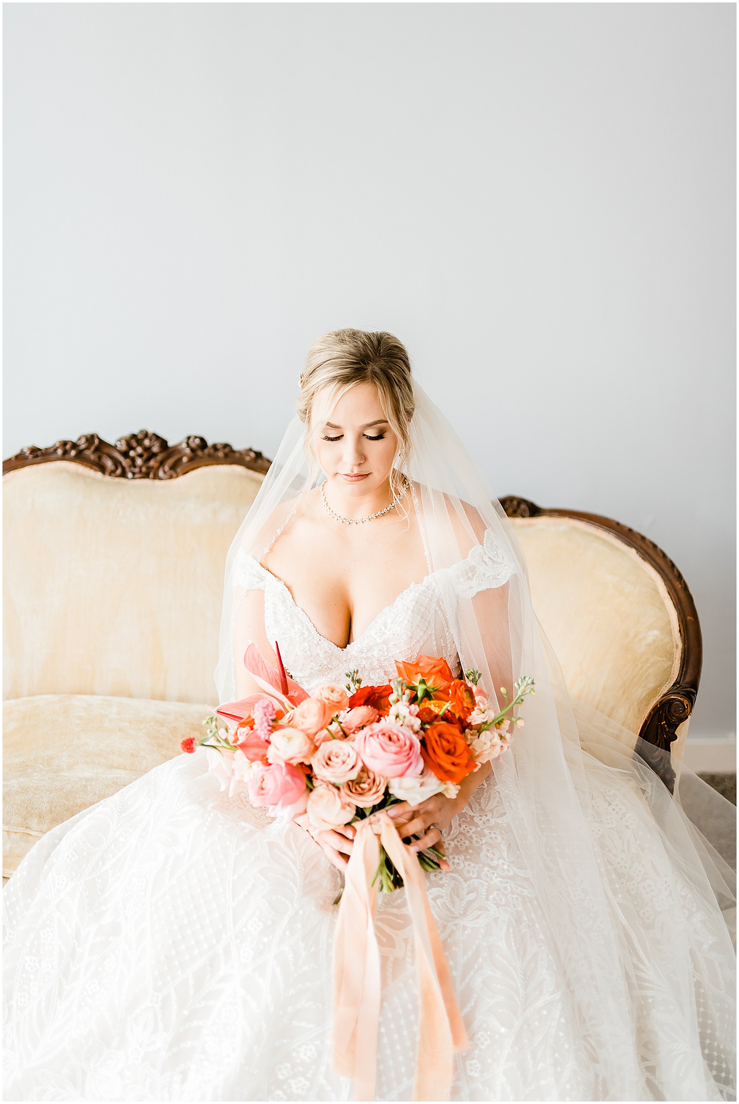 bridal portrait on vintage couch with pink bridal bouquet