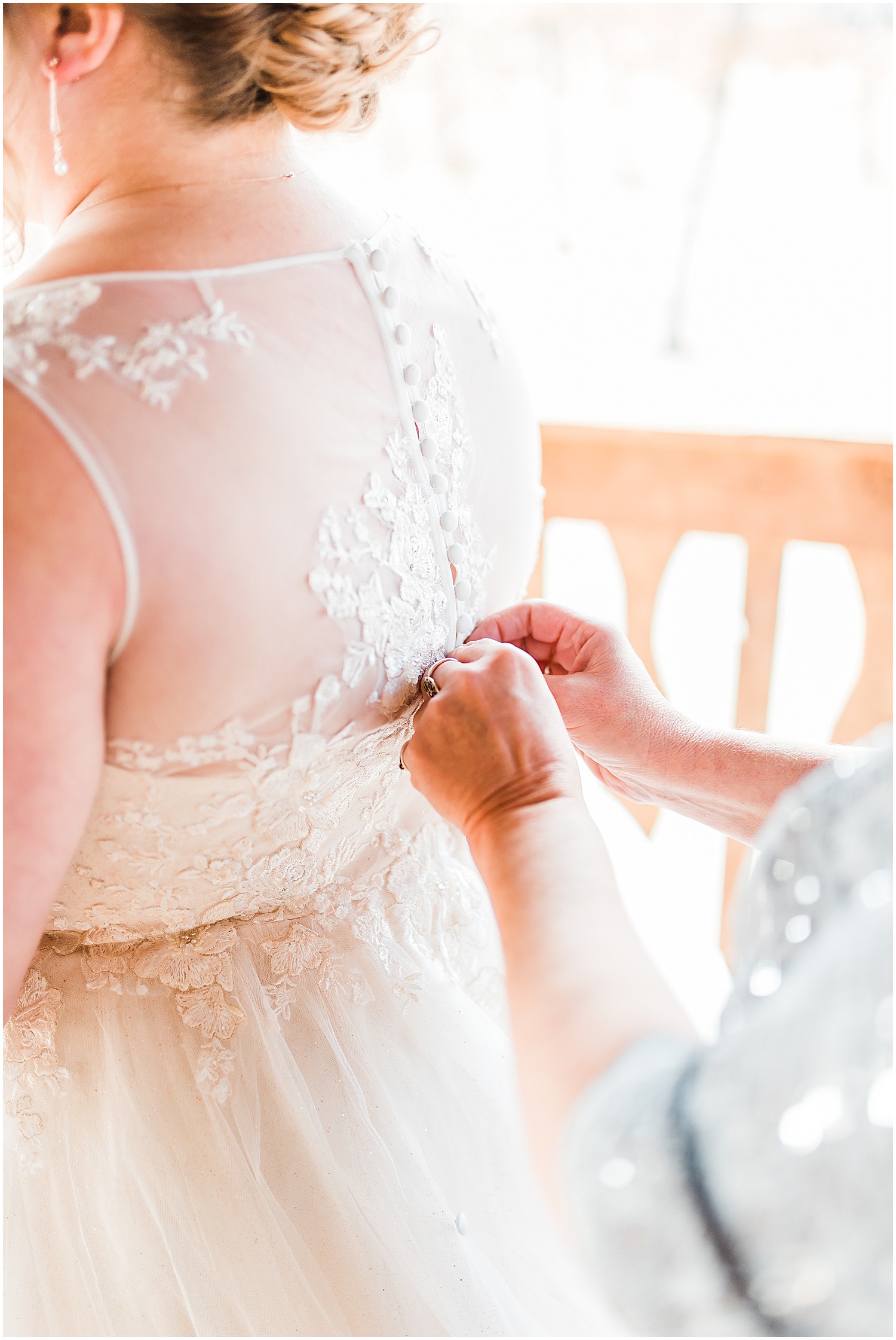 mother of bride buttoning bridal gown weathered wisdom barn