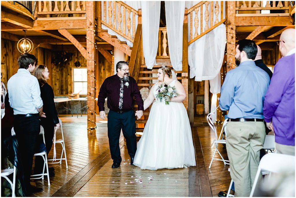 bride and dad walk down aisle weathered wisdom barn wedding