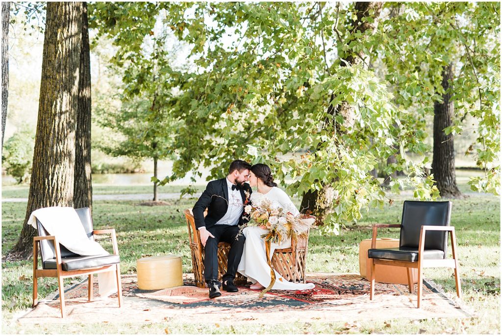 bride and groom sitting in lounge area under trees wildcliff wedding