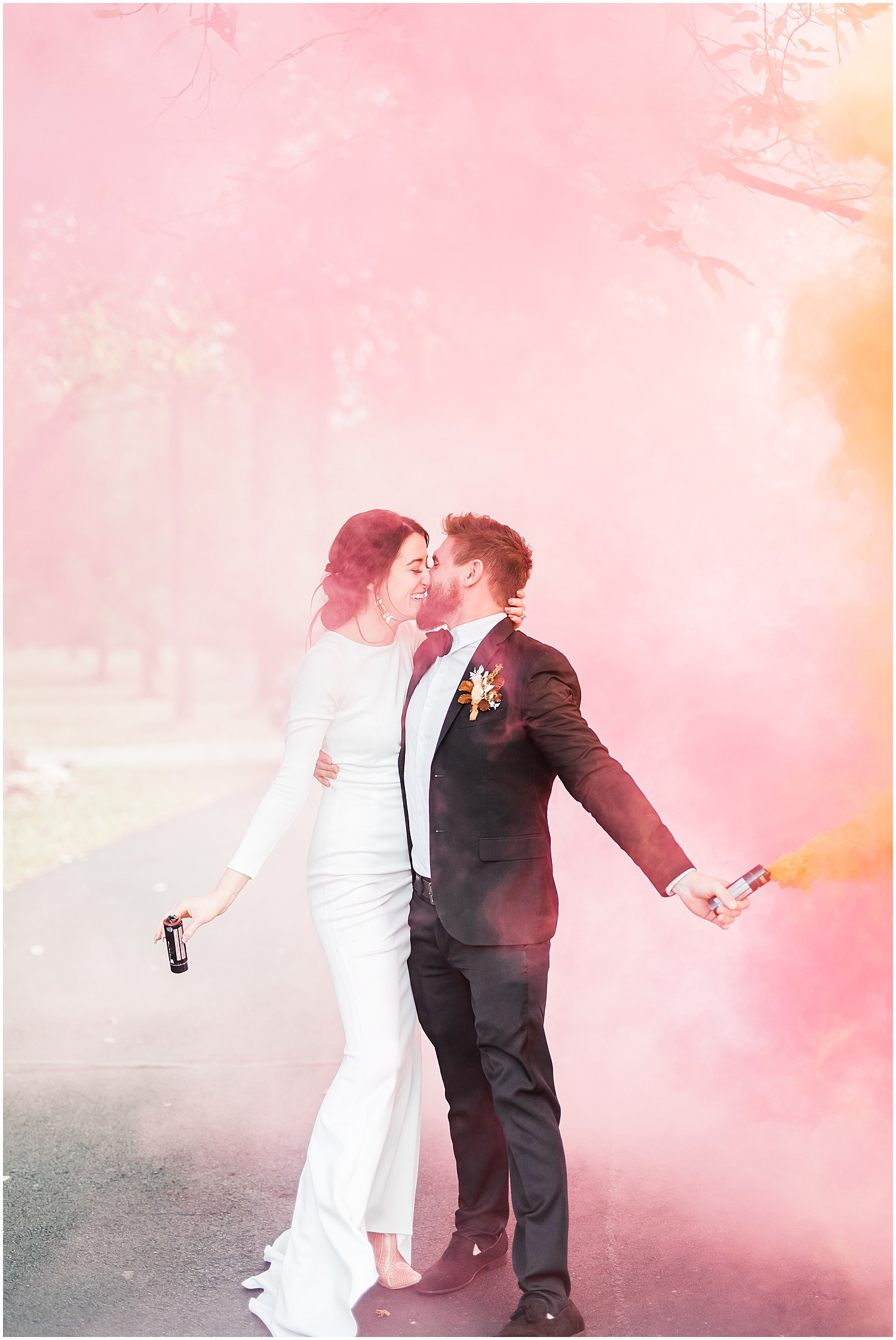 bride and groom pink orange smoke bomb kissing reception exit wildcliff wedding