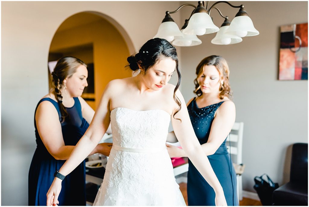 bride getting ready in gown