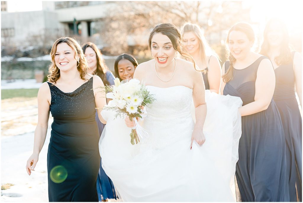 bride walking with bridesmaids sunlight