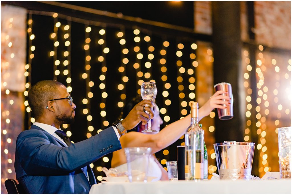 bride and groom toasting wedding reception