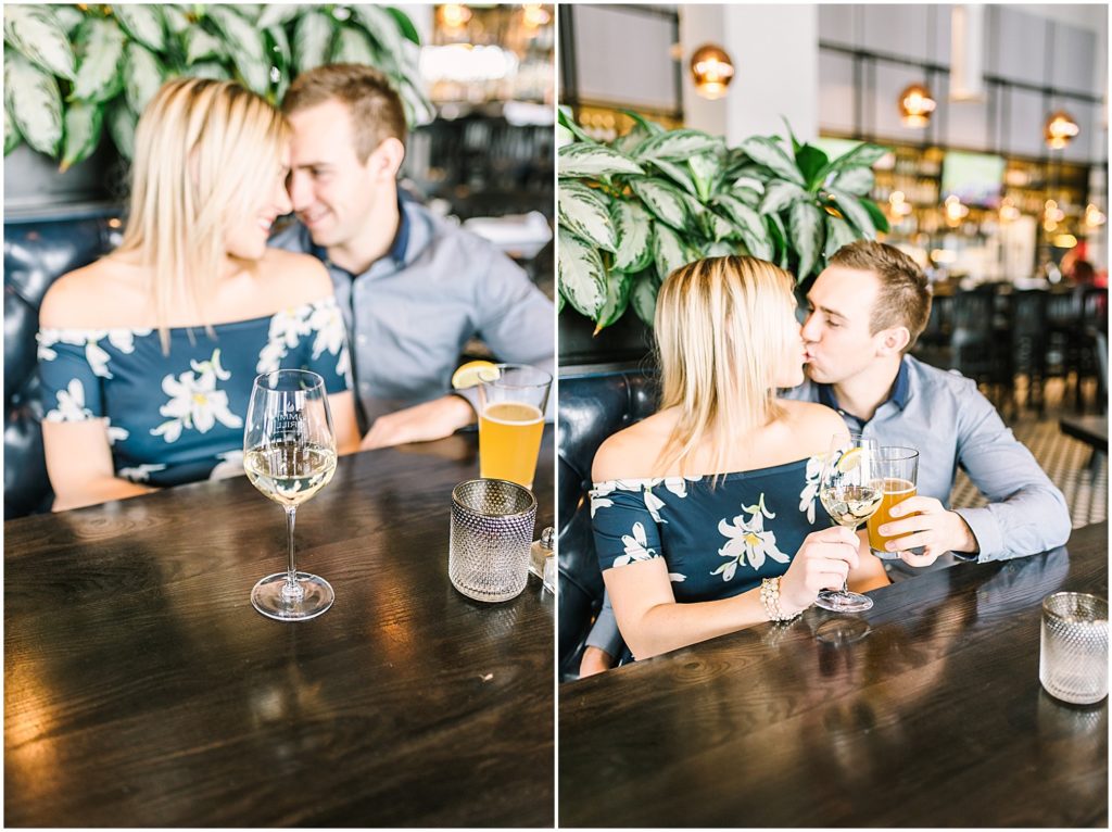 couple toasting in booth at restaurant