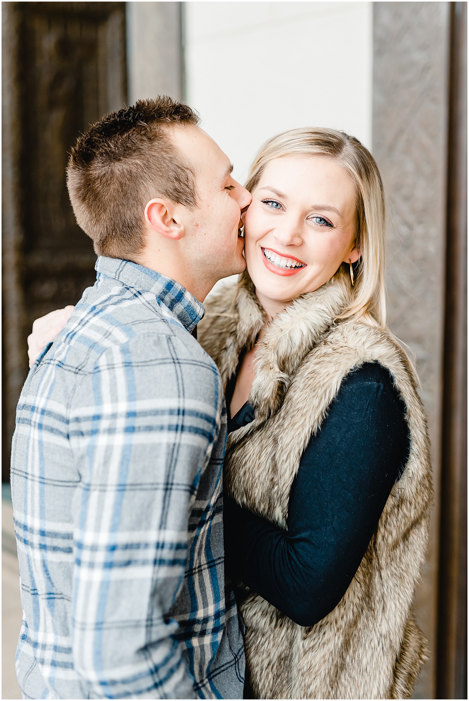 couple kissing and laughing winter engagement session nelson atkins art museum