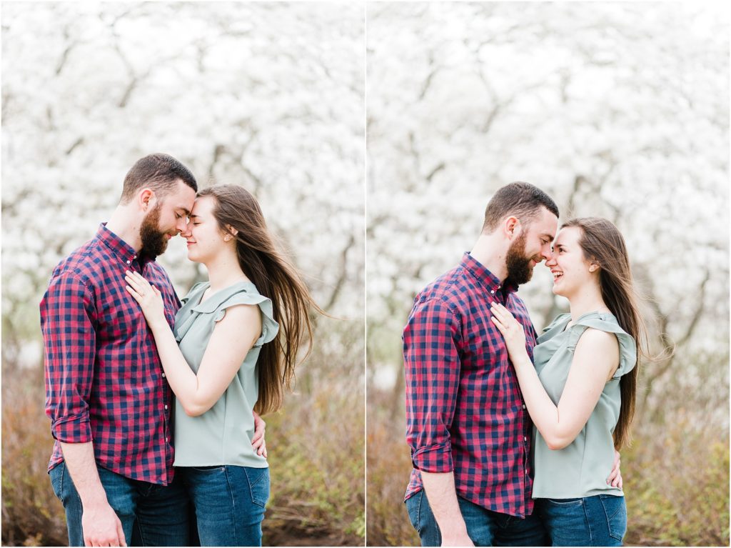 Engaged couples poses in front of magnolia tree for engagement session