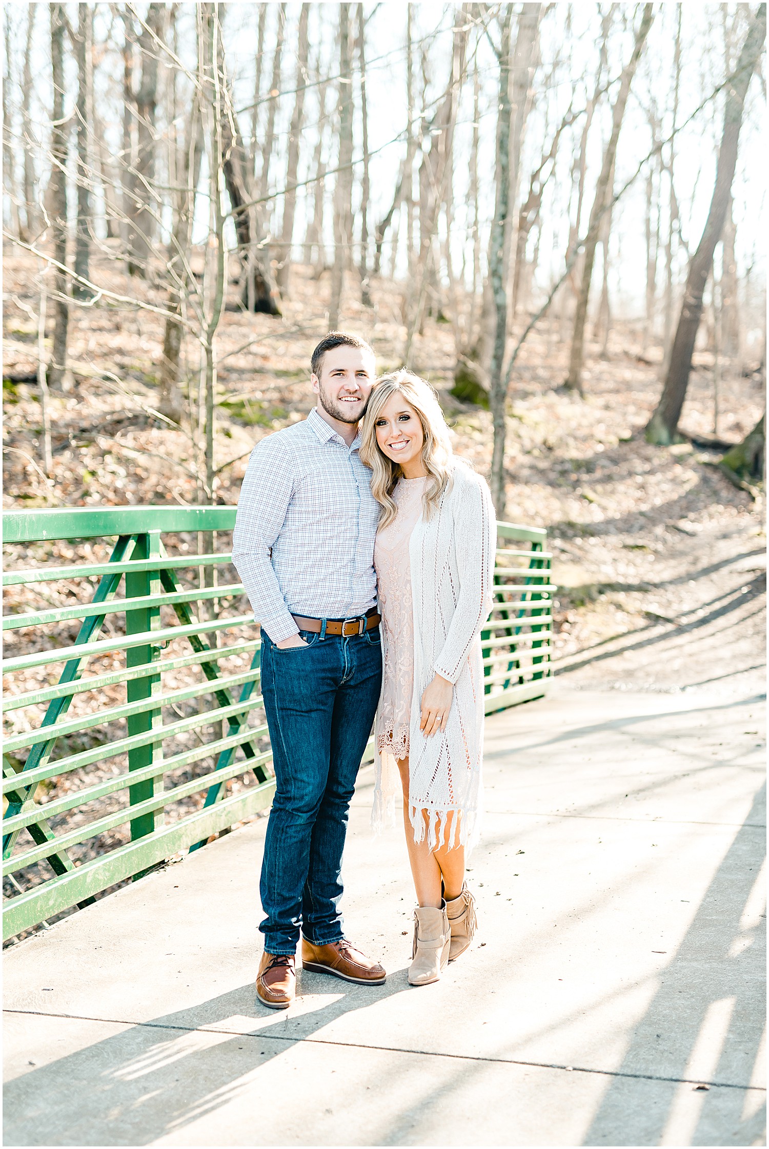 engaged couple on green bridge st. louis engagement session