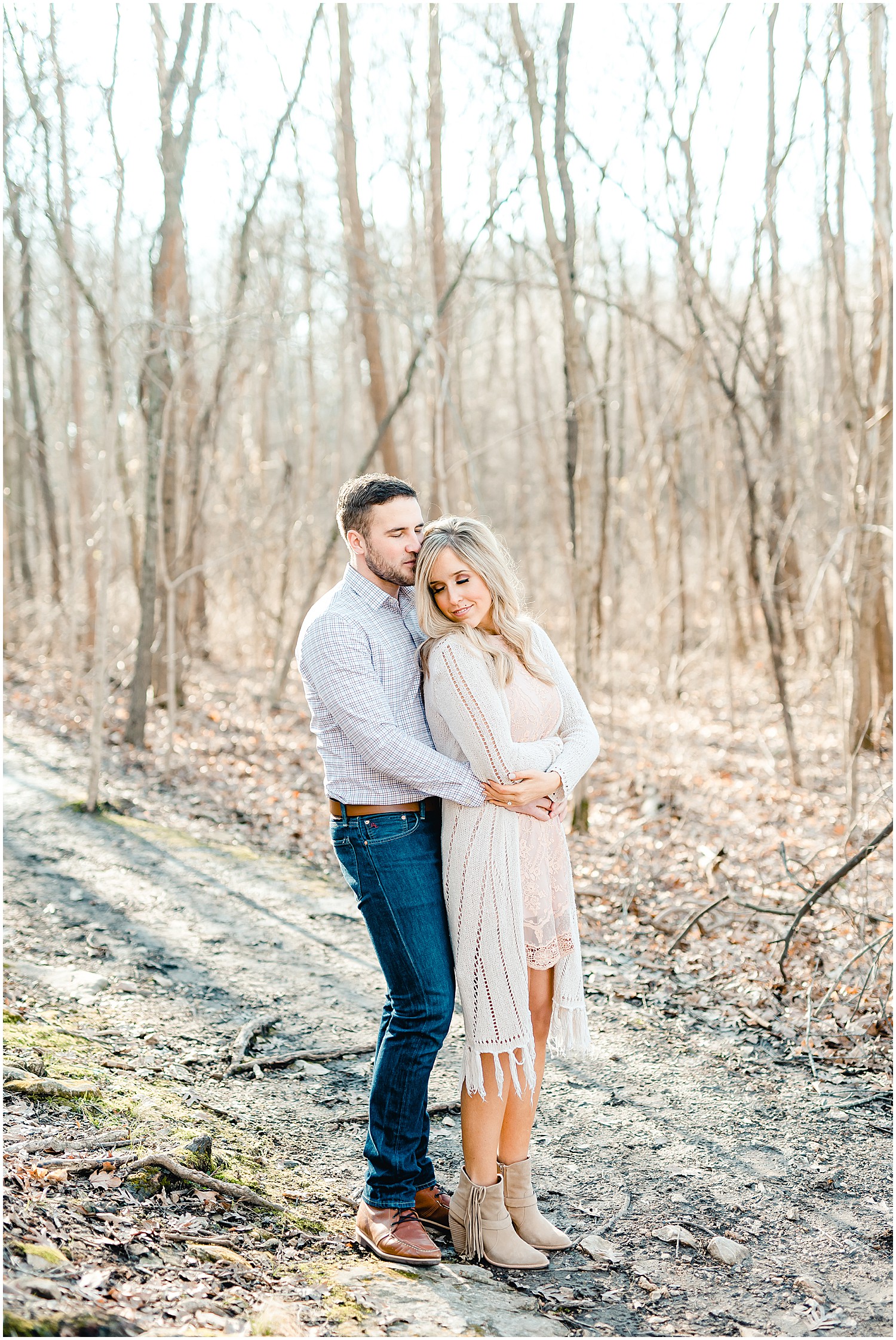 couple standing in woods park engagement session