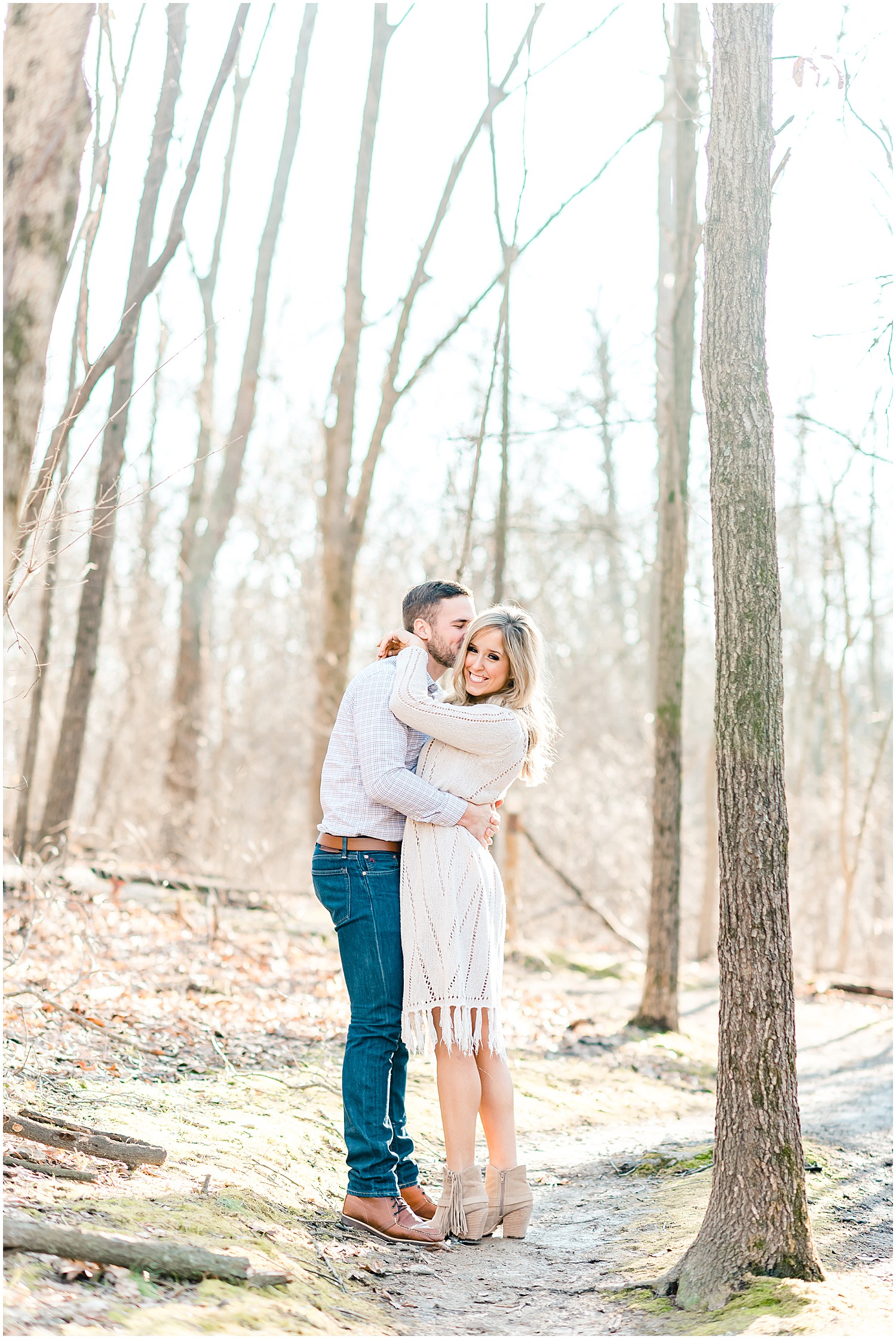 couple kissing in woods st louis engagement session