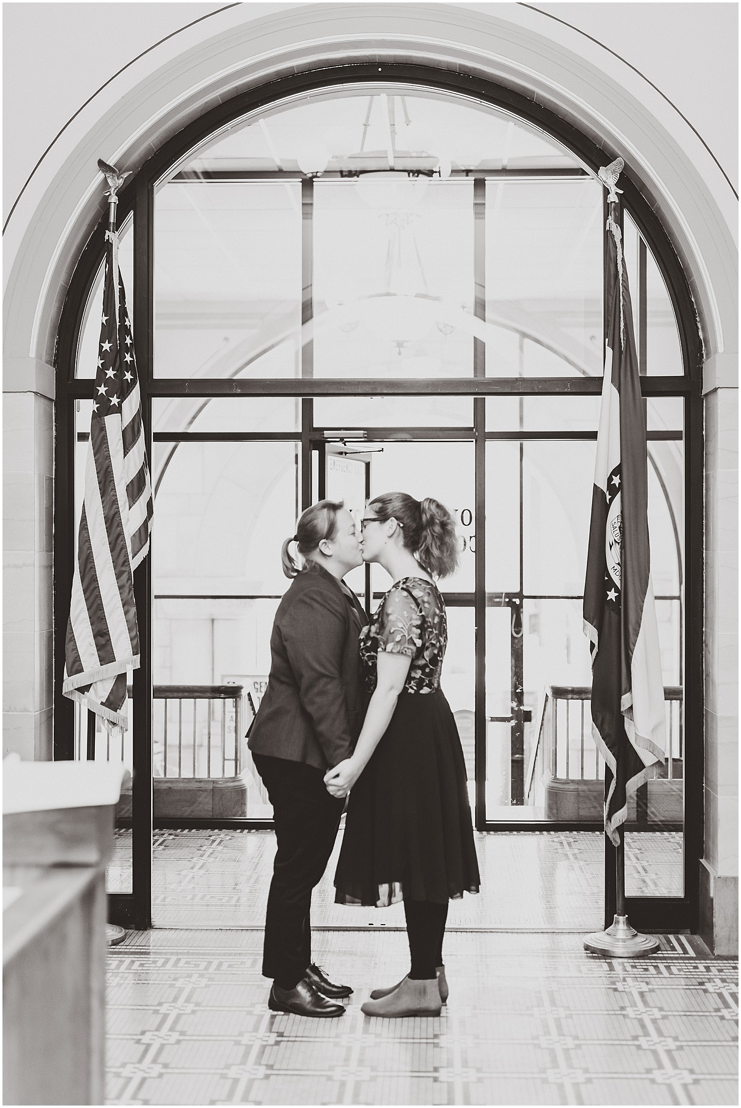 female couple in front of courthouse window black and white