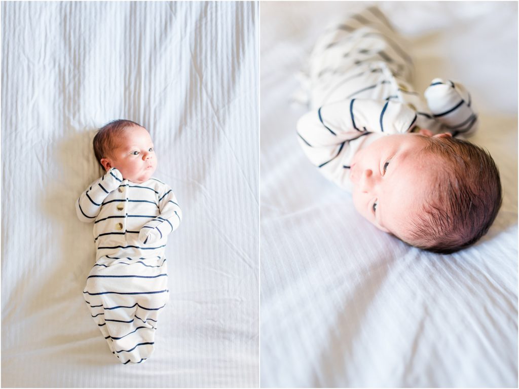 baby boy in blue and white striped pajamas laying on white sheets for newborn session