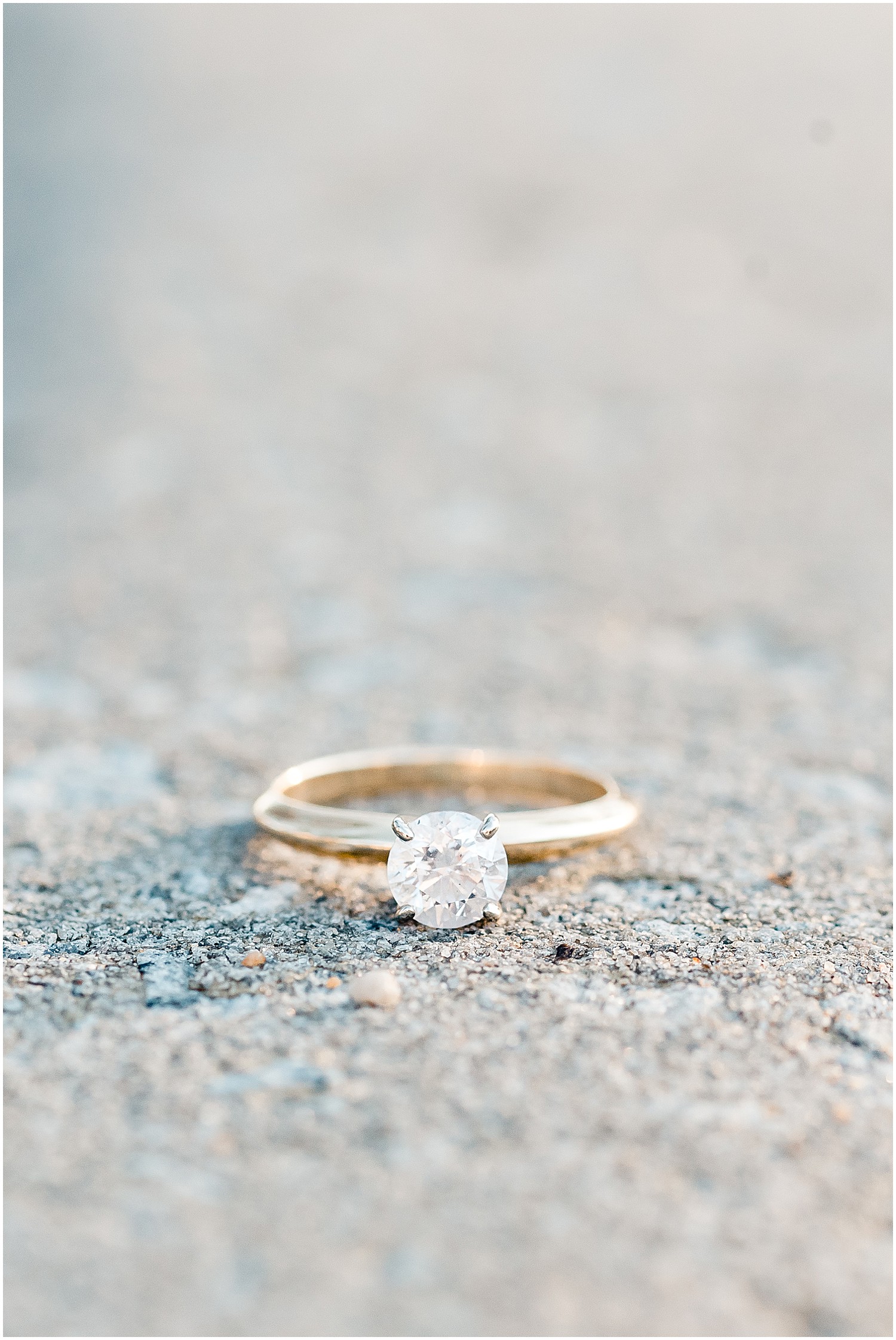Up close image of a large single solitaire engagement ring with gold band