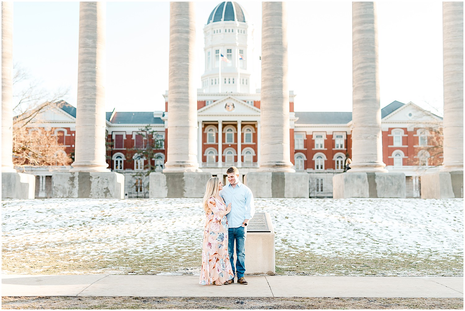 engaged couple standing in front of the mizzou columns