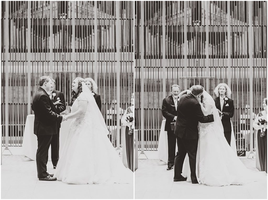 bride and groom first kiss in ceremony black and white images