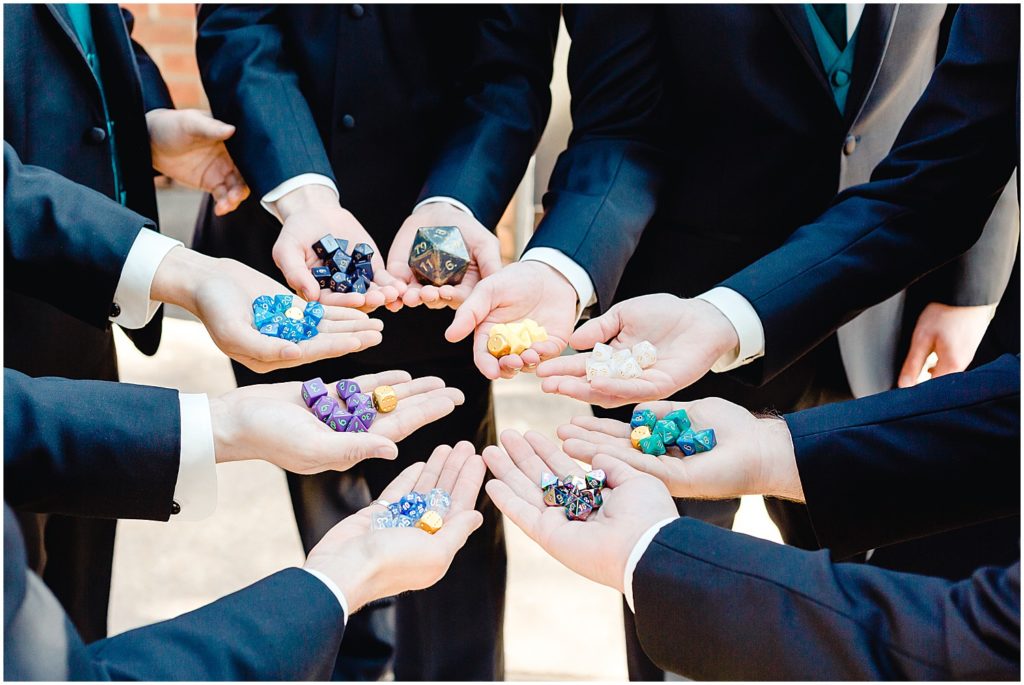 groomsmen holding dungeon's and dragons dice 