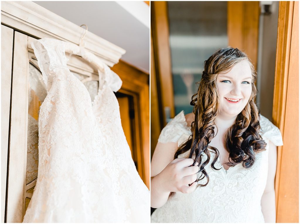 Bride posing next to window in getting ready room wedding gown hanging on armoire
