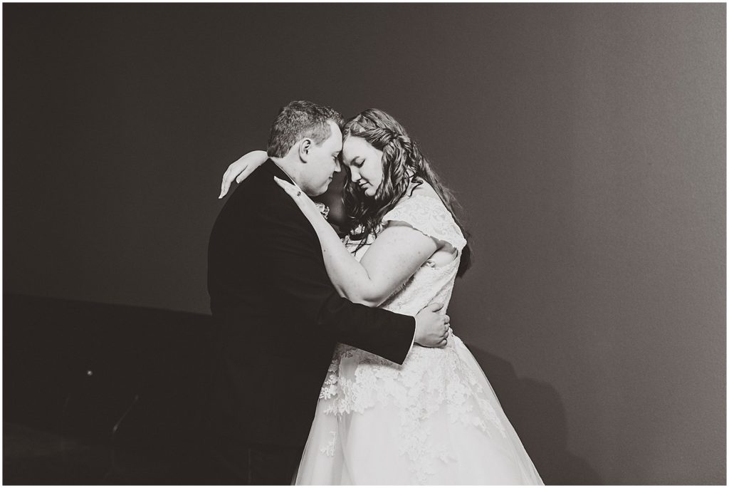 bride and groom dancing their first dance in black and white