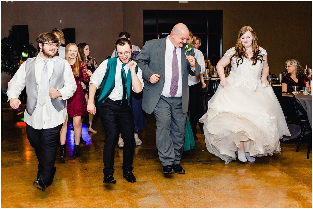 wedding guests and bride dancing during wedding reception