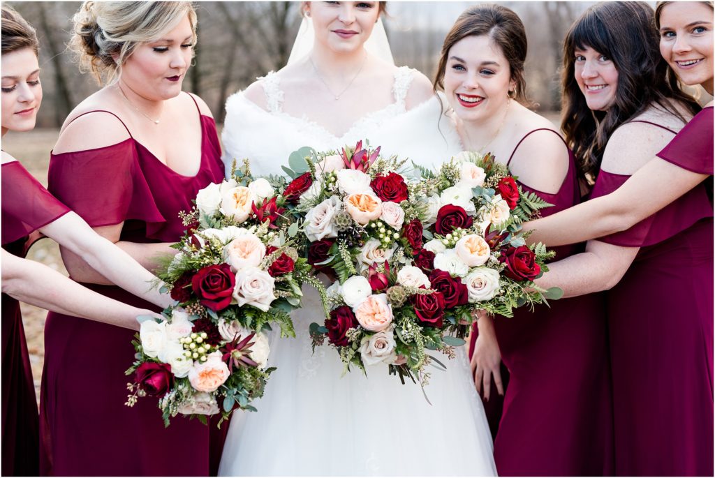 bridal party portraits flowers wine and white colored roses