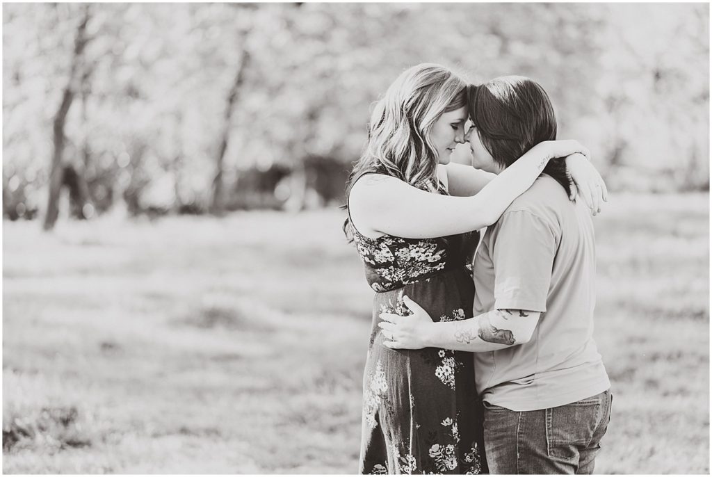 Lesbian couple engagement session on grassy farm in Taos, Missouri