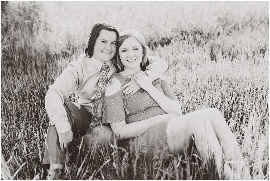 Lesbian couple engagement session on grassy farm in Taos, Missouri