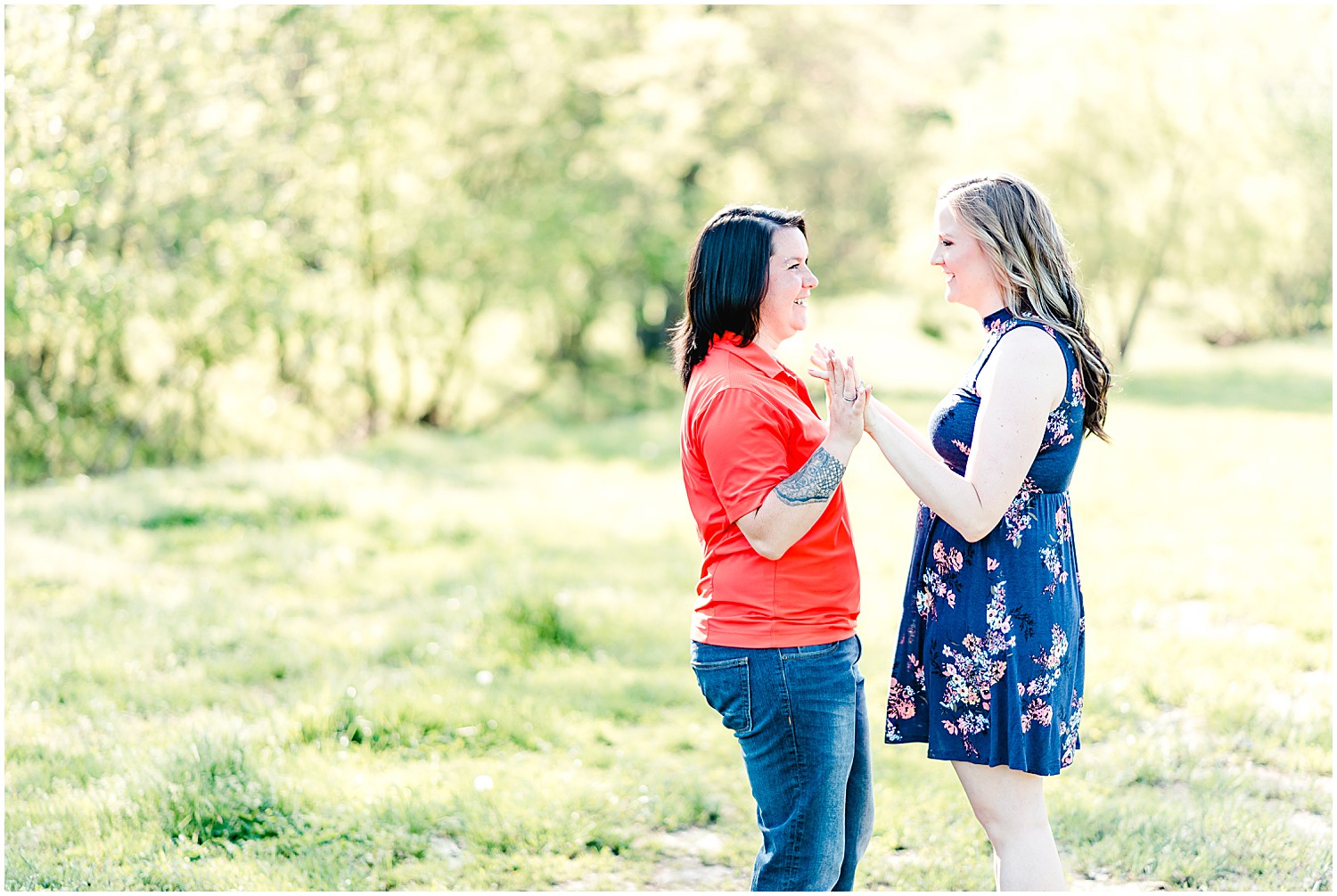 lesbian couple engagement photos on grassy farm