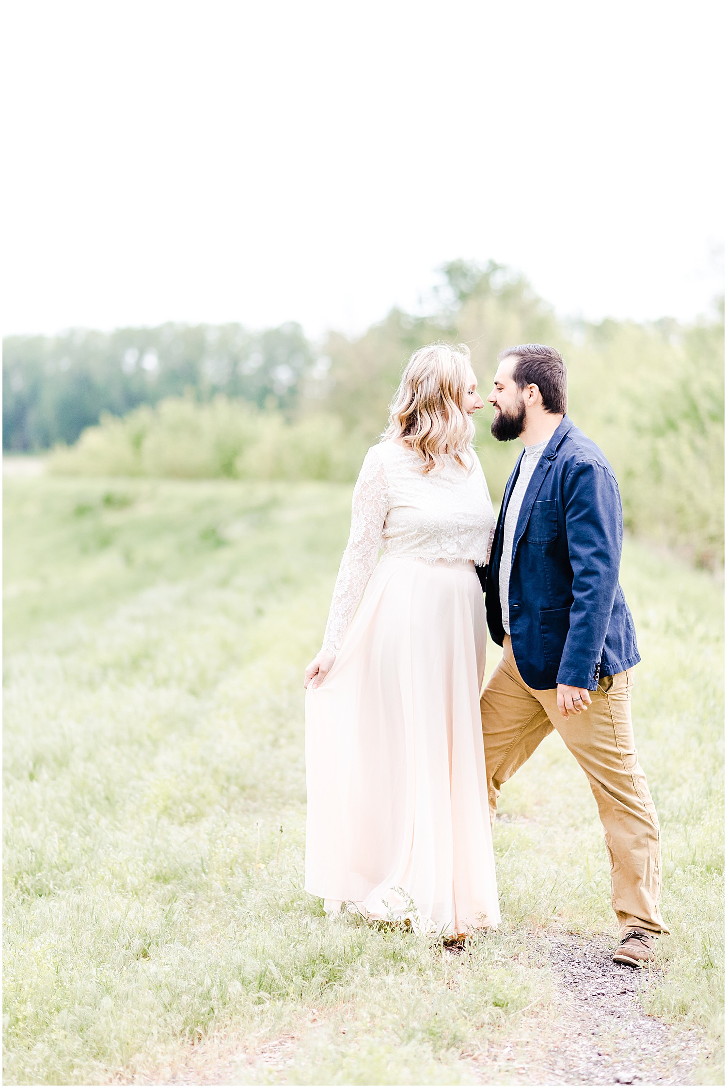 married couple anniversary session with pink and white bouquet