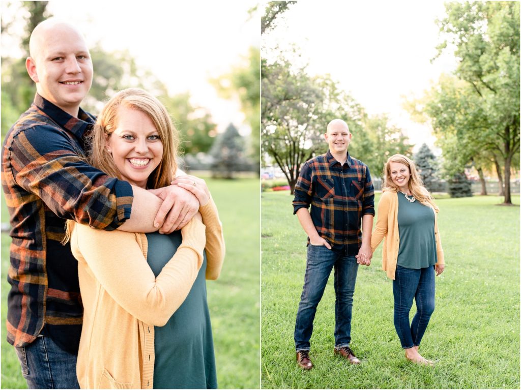 couple wearing fall colors in large grass field for engagement photos in front of missouri capitol building