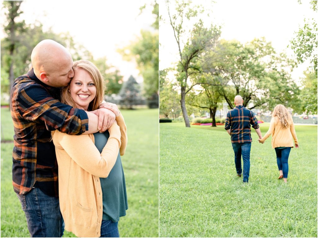 engaged couple walking in grass in front of missouri capitol building for engagement photos