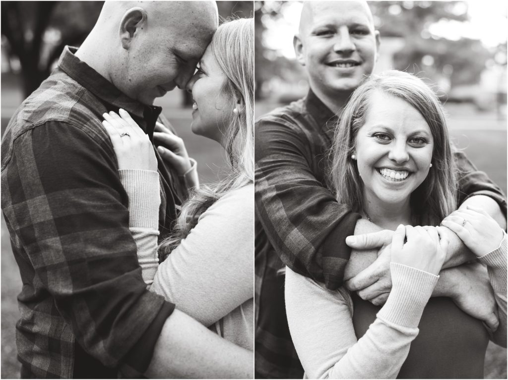 black and white image of couple smiling at camera for engagement photos