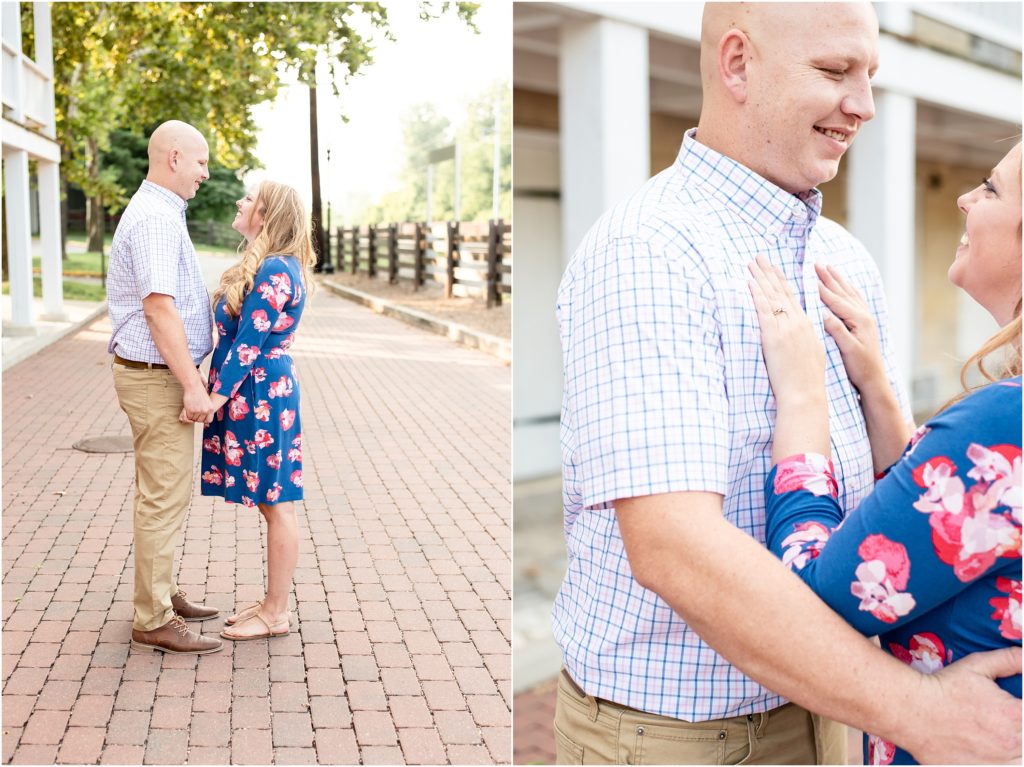 couple standing facing each other on brick road holding hands for engagement photos