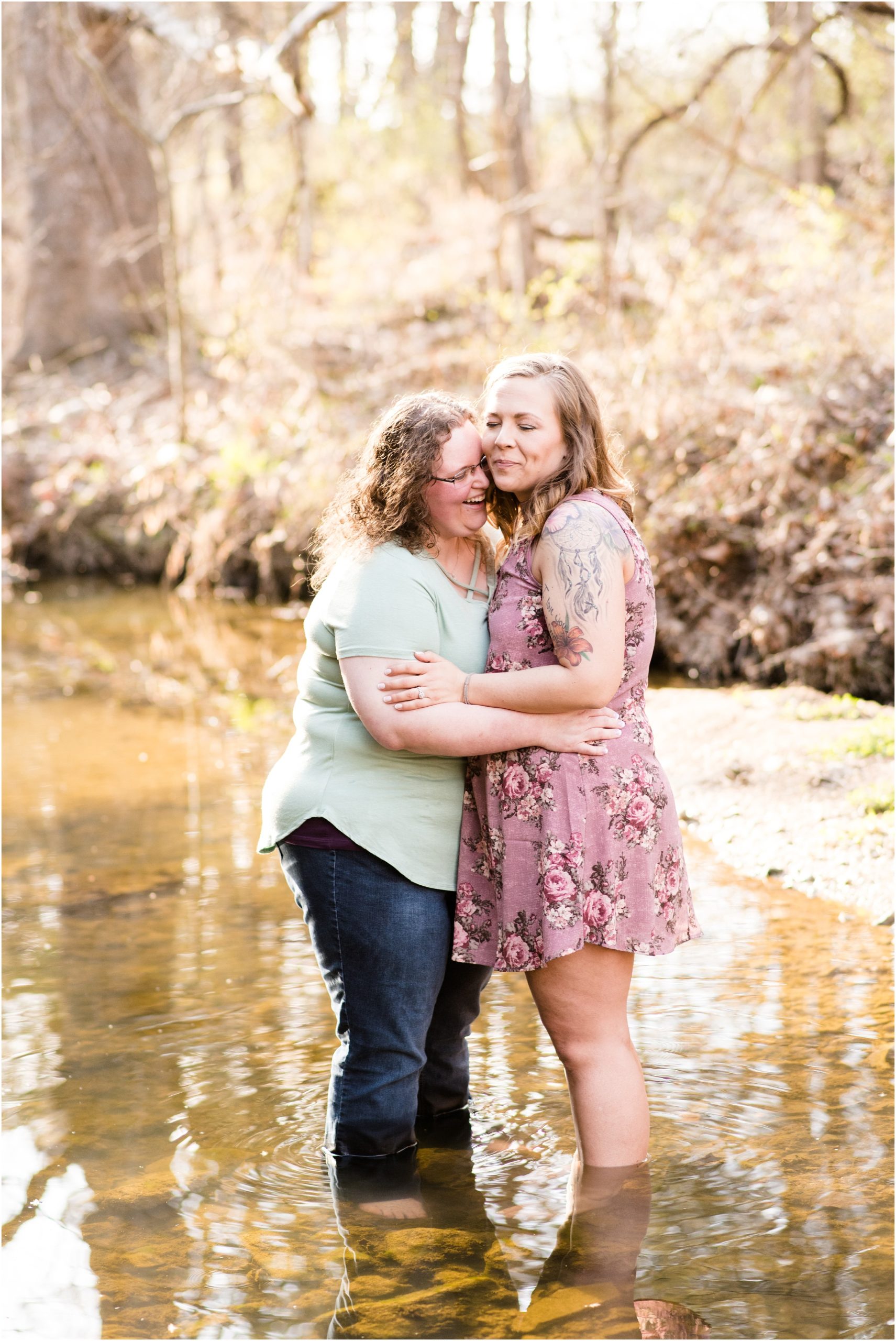 engaged female couple standing in water laughing for Jefferson City mo engagement photos