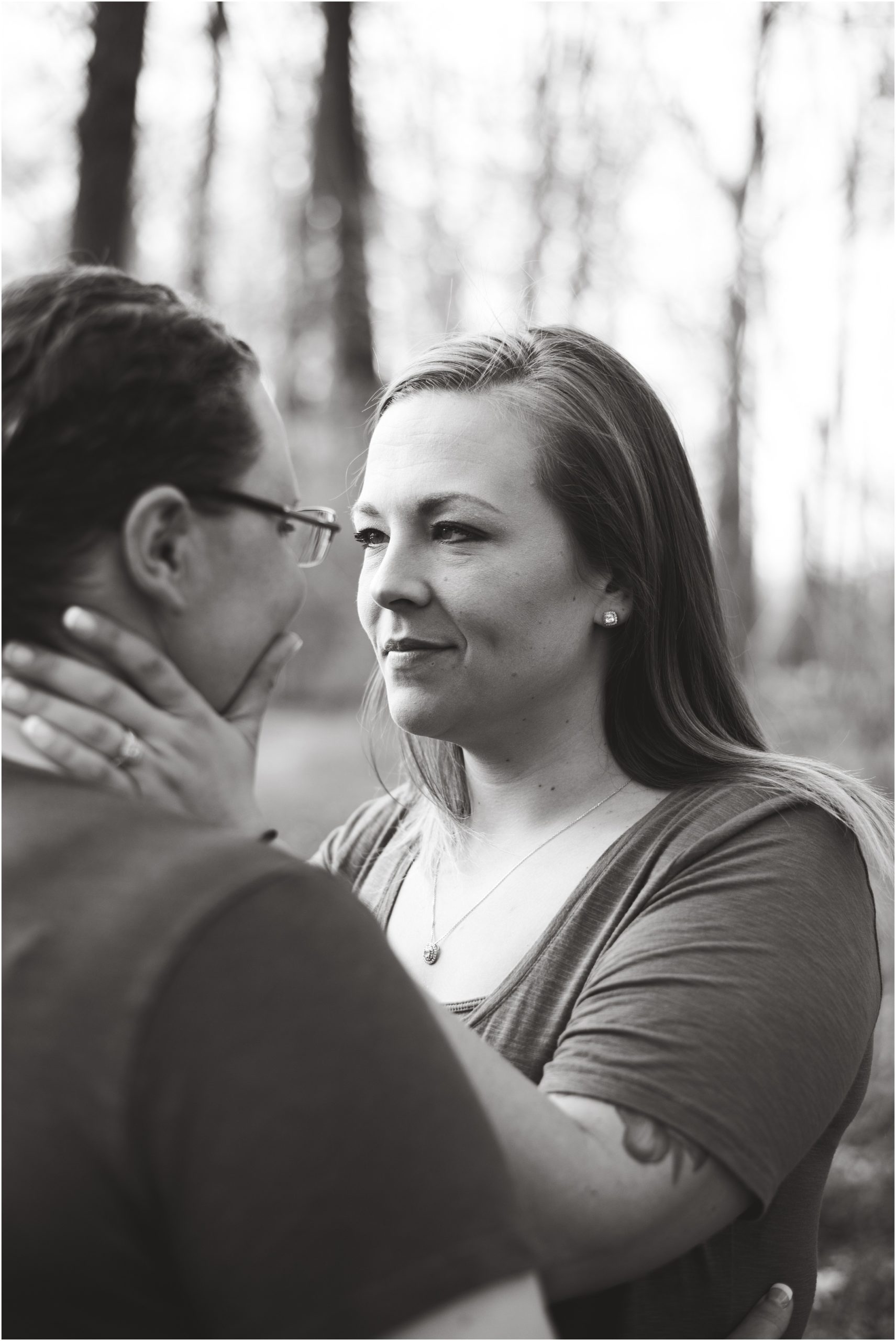 black and white image of engaged couple staring at each other for engagement photos