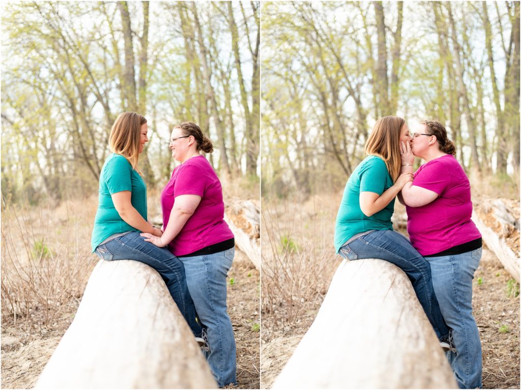 engaged female couple sitting on fallen tree at noren river access for Jefferson City, mo engagement photos