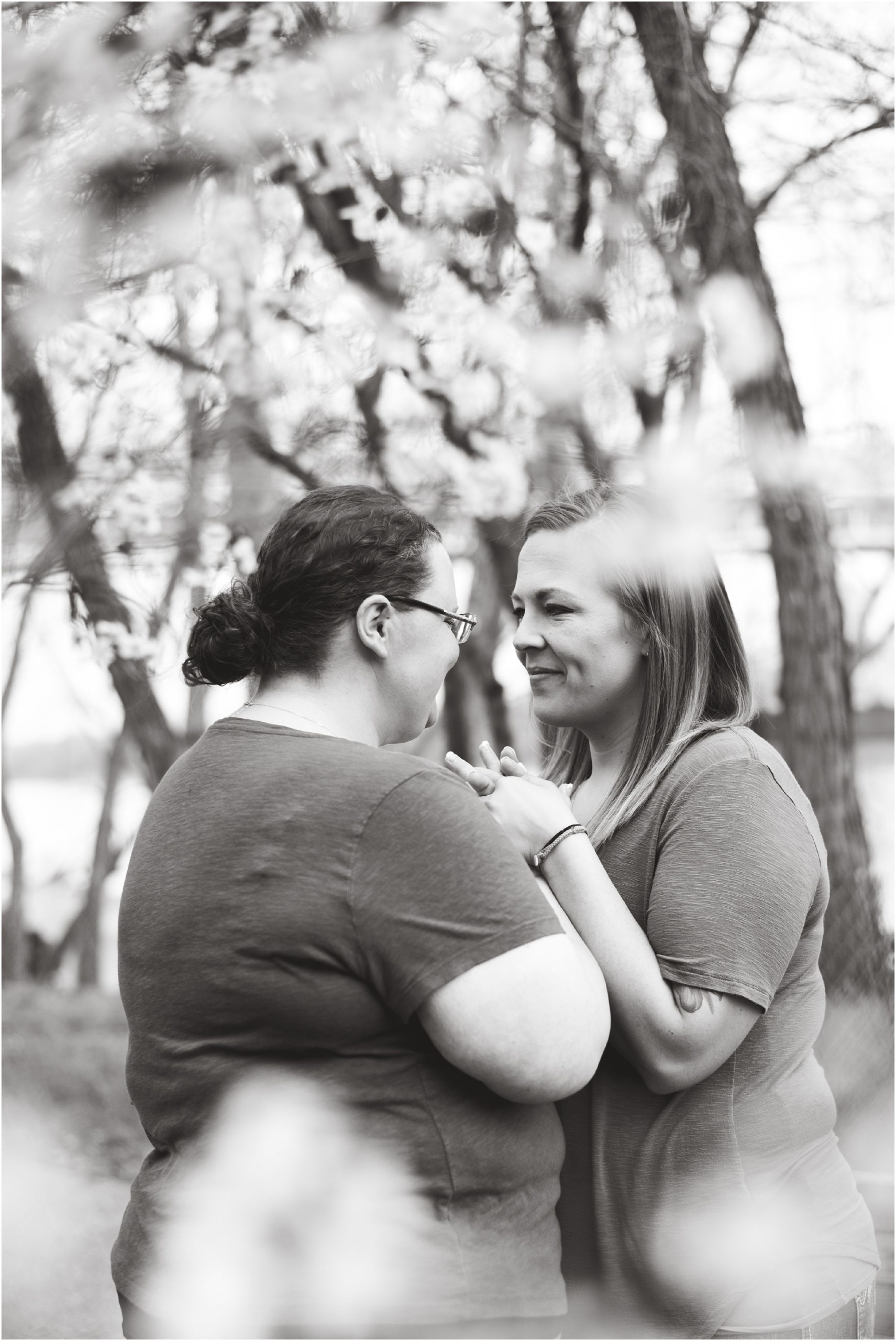 black and white image of females holding hands for engagement session in Jefferson City mo