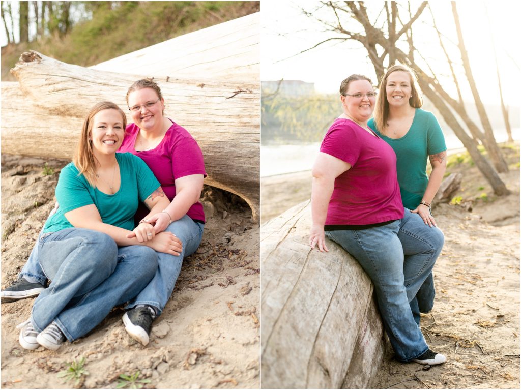 engaged couple sitting on sand against fallen tree at noren river access for Jefferson City engagement session