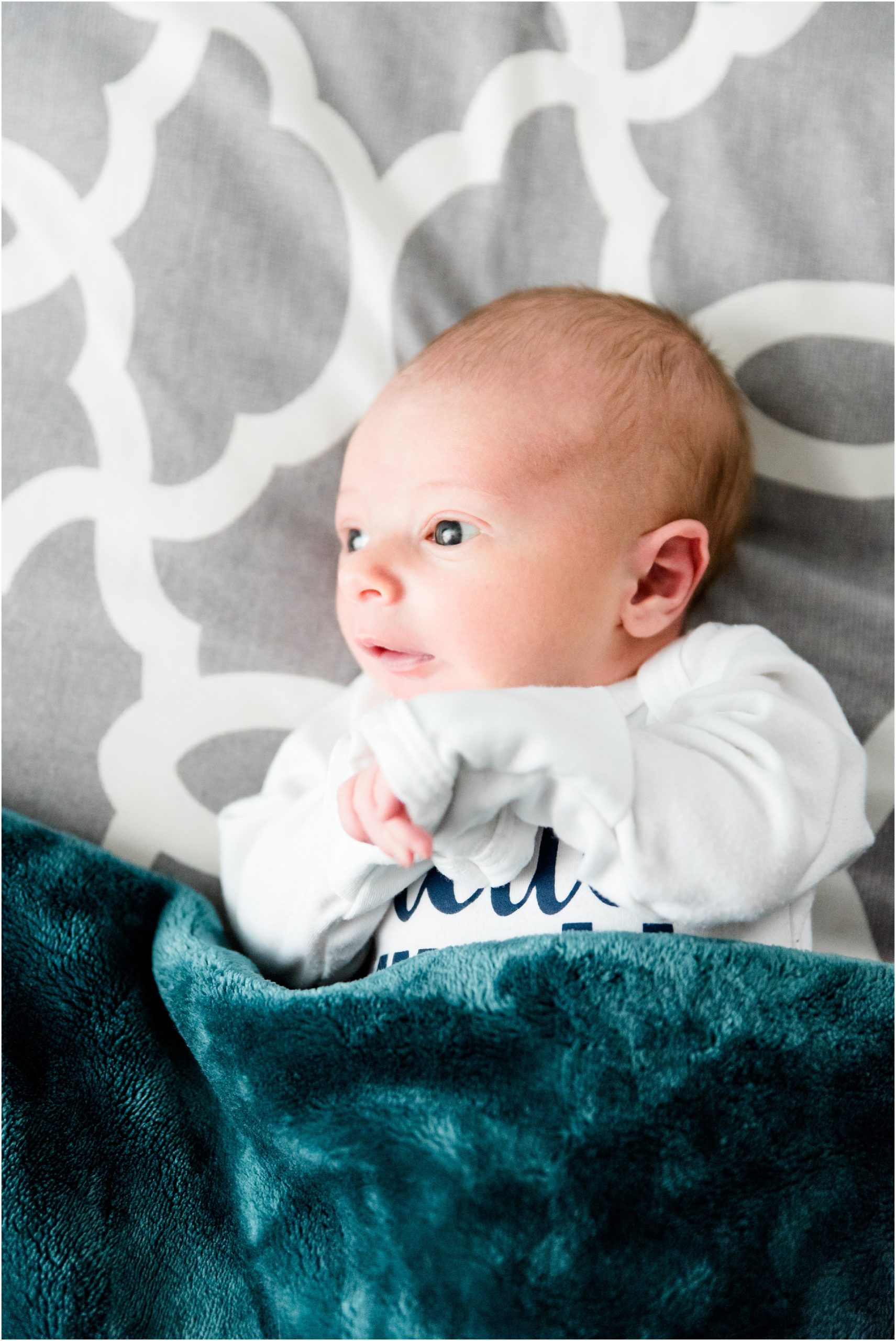baby boy newborn session with blue blanket staring into light