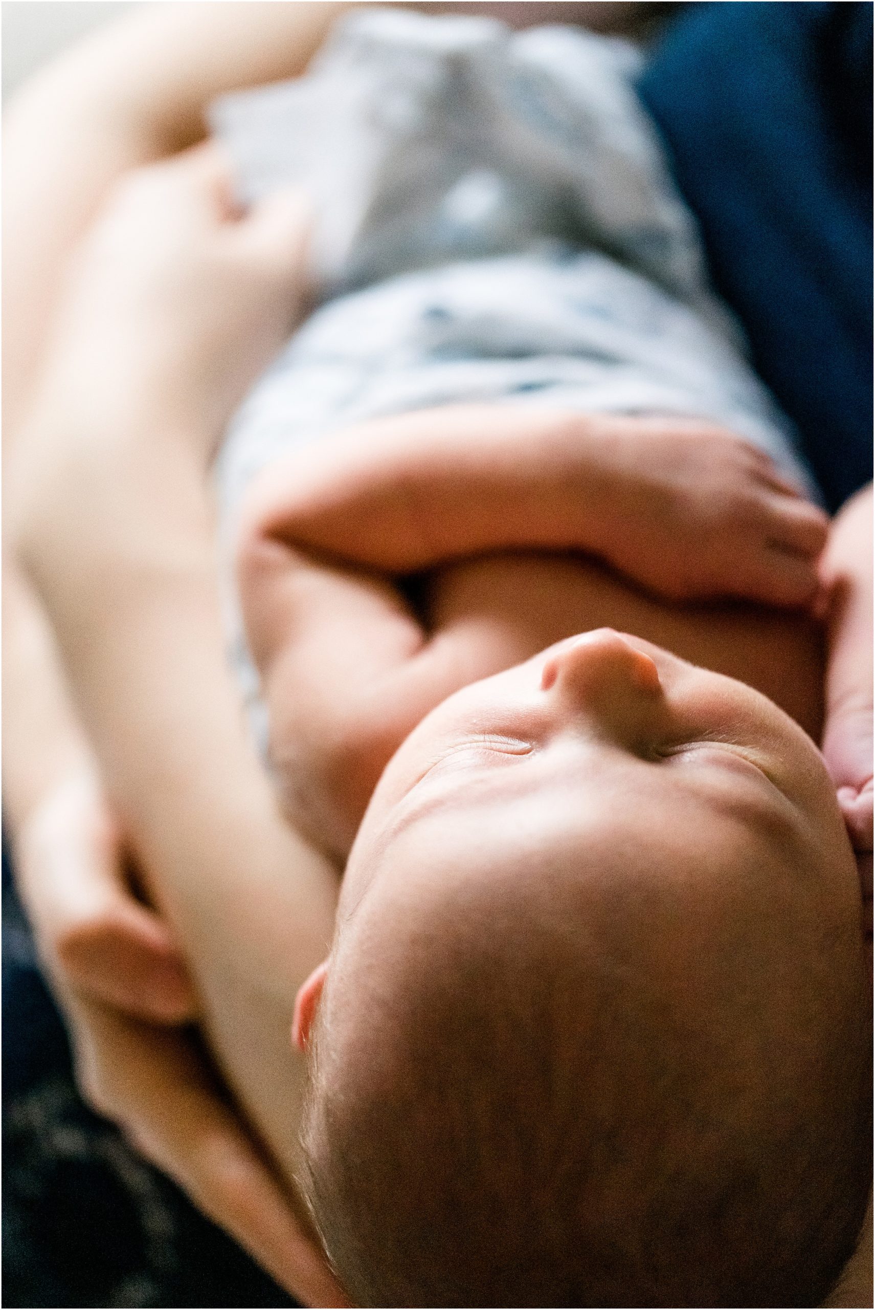 detail images of baby boy sleeping on mom's lap in blue swaddle for jefferson city newborn session