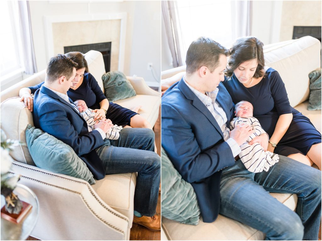 mom and dad sitting on couch with newborn baby boy for newborn session