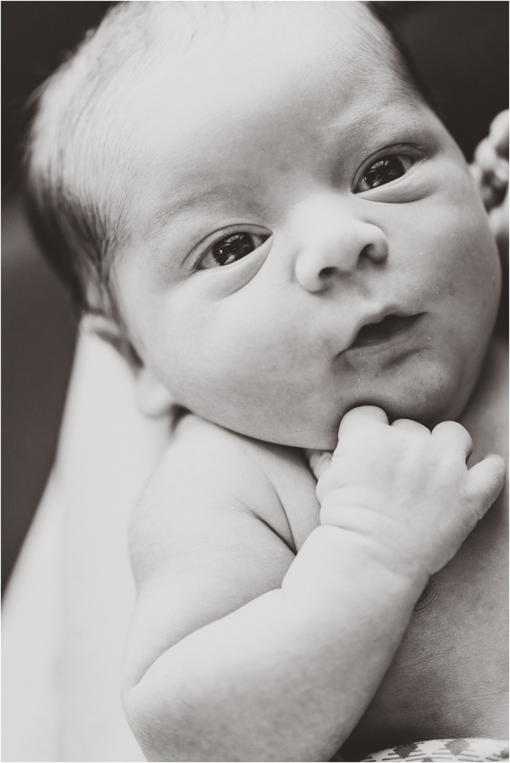 black and white image of newborn baby face up close for newborn session