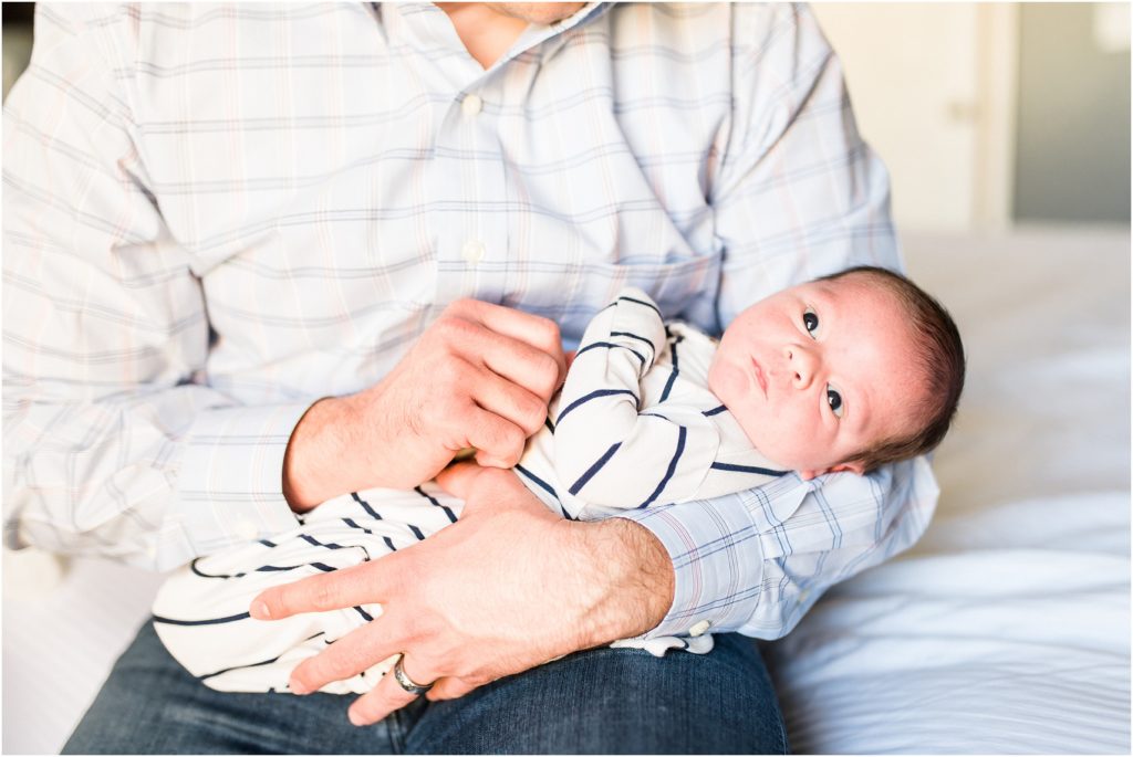baby boy being held by dad for newborn session