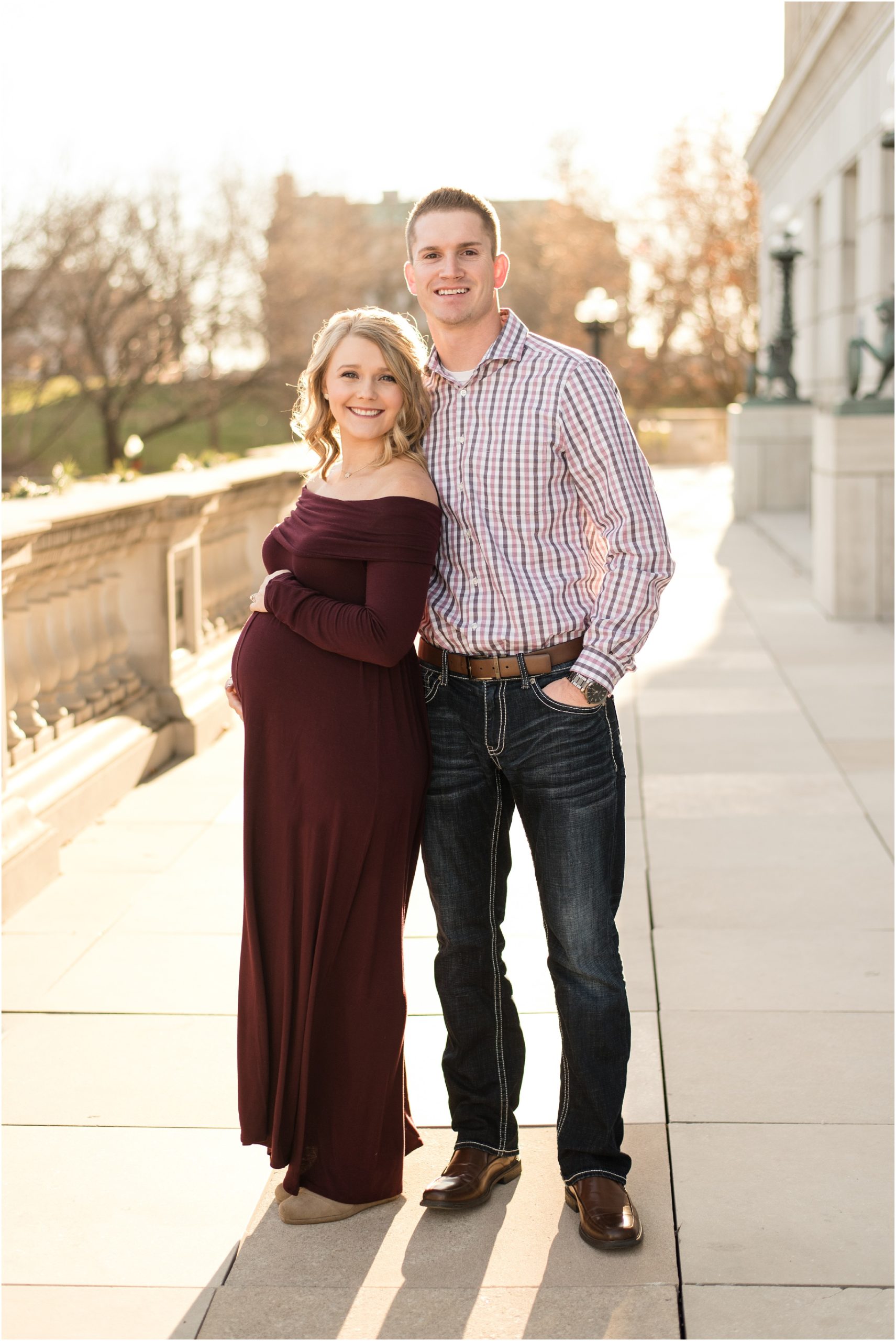 couple standing in sunlight of missouri state capitol for maternity session